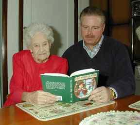 Image: Author, John Snyder, and his grandmother read The Golden Ring at the kitchen table.